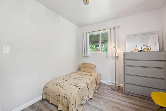 2419 Faye Dr, Ann Arbor, MI 48103 - bedroom with wood finished floors, baseboards, and vaulted ceiling
