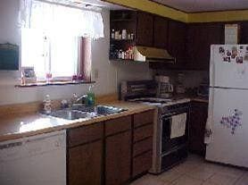 1175 Hammond Rd, Hastings, MI 49058 - kitchen featuring white appliances, ventilation hood, light countertops, light tile patterned flooring, and open shelves