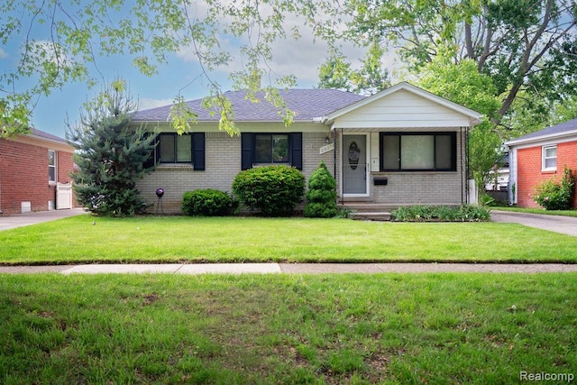 29974 Tamarack Dr, Flat Rock, MI 48134 - ranch-style house featuring brick siding and a front yard