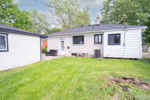 29974 Tamarack Dr, Flat Rock, MI 48134 - rear view of house featuring a chimney, a patio area, and roof with shingles