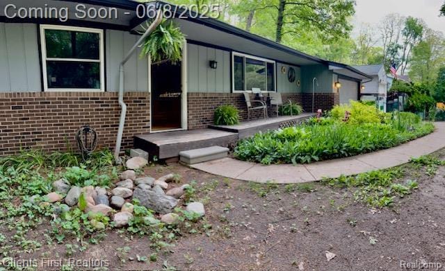 5844 Crandall Rd, Howell, MI 48855 - entrance to property with brick siding and board and batten siding