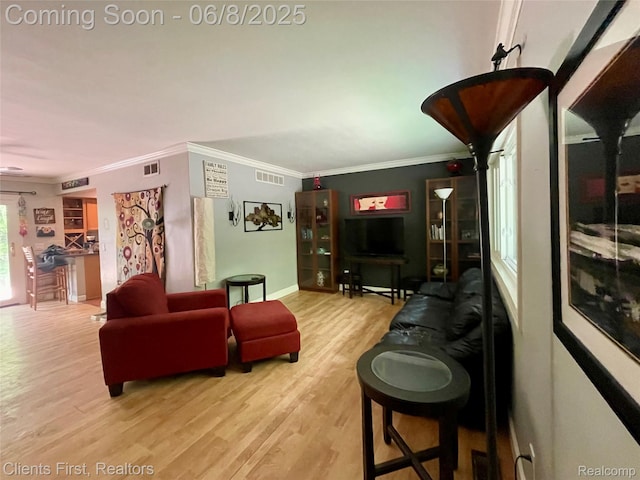 5844 Crandall Rd, Howell, MI 48855 - living area featuring ornamental molding, wood finished floors, and baseboards