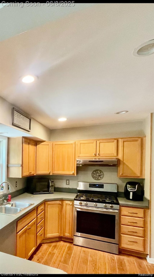 5844 Crandall Rd, Howell, MI 48855 - kitchen featuring stainless steel gas range oven, a sink, light wood finished floors, recessed lighting, and light brown cabinetry