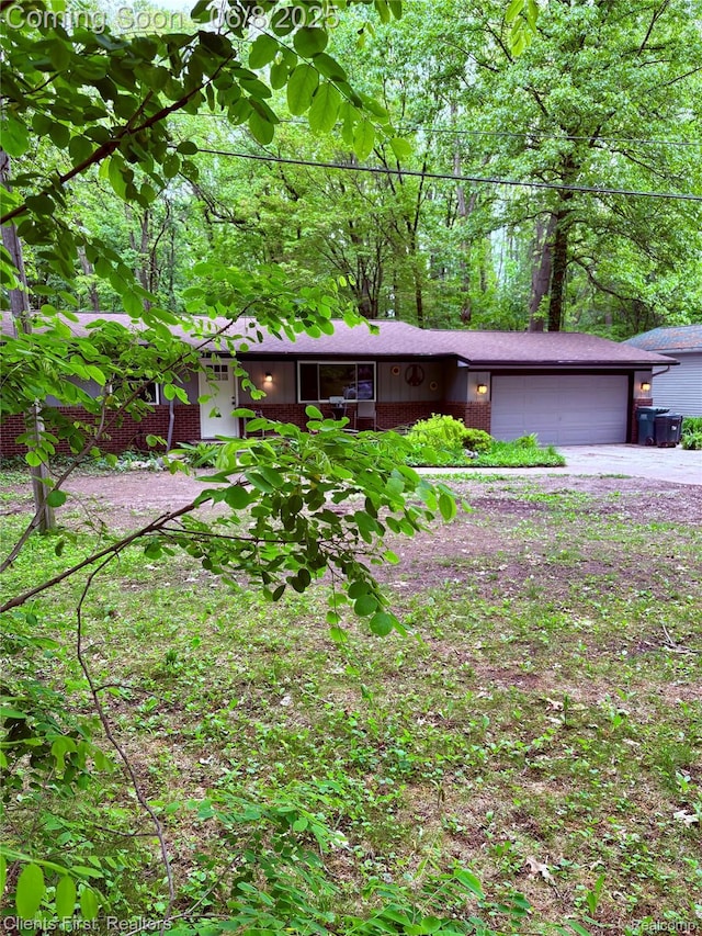 5844 Crandall Rd, Howell, MI 48855 - view of front of property with brick siding, a garage, and driveway