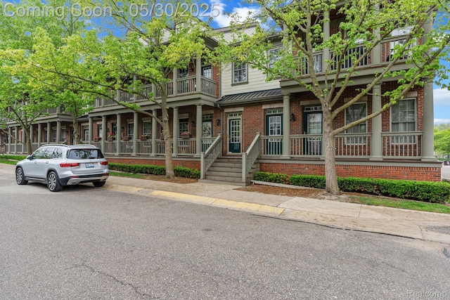 239 Jotham Ave, Auburn Hills, MI 48326 - townhome / multi-family property with brick siding, a balcony, and covered porch