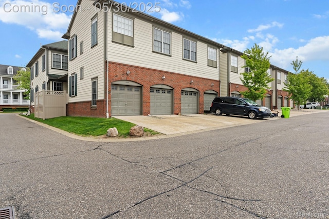 239 Jotham Ave, Auburn Hills, MI 48326 - view of building exterior with an attached garage and concrete driveway