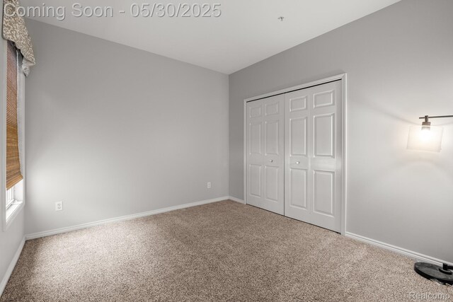 239 Jotham Ave, Auburn Hills, MI 48326 - unfurnished bedroom with carpet, baseboards, and a closet
