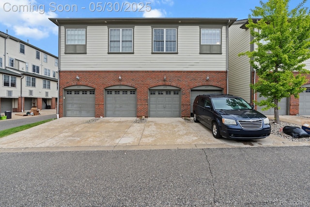 239 Jotham Ave, Auburn Hills, MI 48326 - view of property featuring brick siding, an attached garage, and concrete driveway