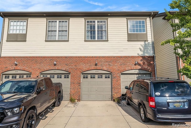 239 Jotham Ave, Auburn Hills, MI 48326 - view of front of house with brick siding, driveway, and a garage