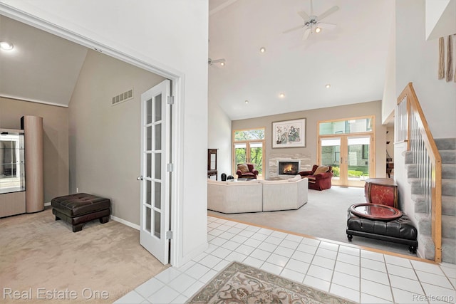 5299 Pond Bluff Dr, West Bloomfield, MI 48323 - living area featuring carpet flooring, french doors, high vaulted ceiling, tile patterned floors, and stairs