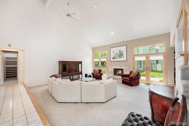 5299 Pond Bluff Dr, West Bloomfield, MI 48323 - living room with high vaulted ceiling, light colored carpet, a warm lit fireplace, a ceiling fan, and recessed lighting