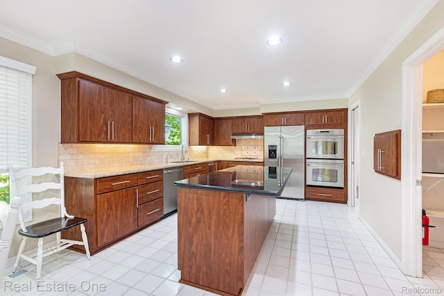5299 Pond Bluff Dr, West Bloomfield, MI 48323 - kitchen with stainless steel appliances, a sink, tasteful backsplash, under cabinet range hood, and stone counters