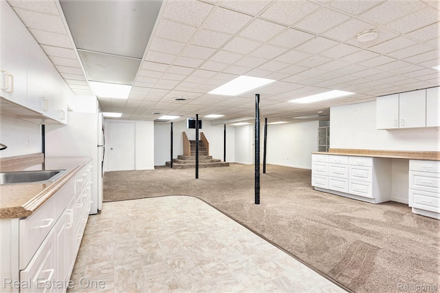 5299 Pond Bluff Dr, West Bloomfield, MI 48323 - finished below grade area with light carpet, a sink, stairway, and freestanding refrigerator