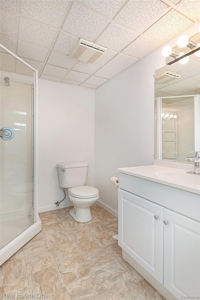 5299 Pond Bluff Dr, West Bloomfield, MI 48323 - bathroom featuring a drop ceiling, vanity, a stall shower, toilet, and baseboards