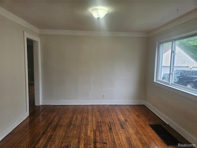 4634 8th St, Ecorse, MI 48229 - spare room featuring dark wood-style flooring and baseboards