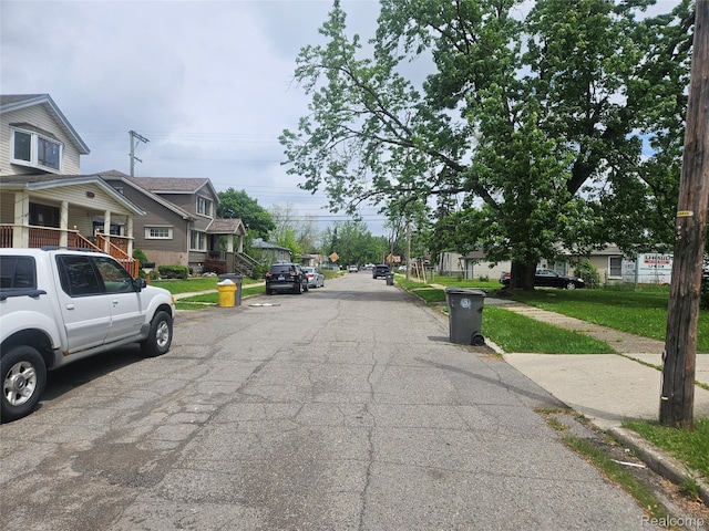 4634 8th St, Ecorse, MI 48229 - view of asphalt street featuring a residential view, sidewalks, and curbs