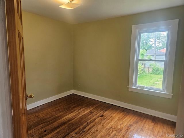 4634 8th St, Ecorse, MI 48229 - spare room with dark wood-style floors and baseboards