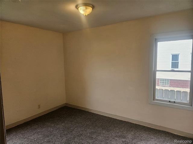 4634 8th St, Ecorse, MI 48229 - unfurnished room featuring dark colored carpet and baseboards