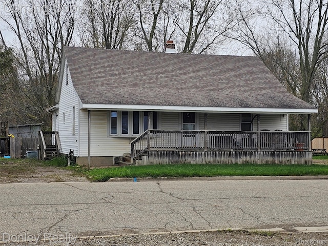 292 Lexington St, Sandusky, MI 48471 - view of front of house with covered porch, a chimney, and roof with shingles