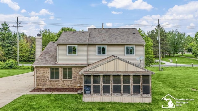 177 W Willis Rd, Saline, MI 48176 - rear view of house with a sunroom, brick siding, a yard, and a chimney