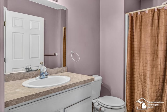 177 W Willis Rd, Saline, MI 48176 - bathroom featuring vanity, toilet, and a shower with curtain