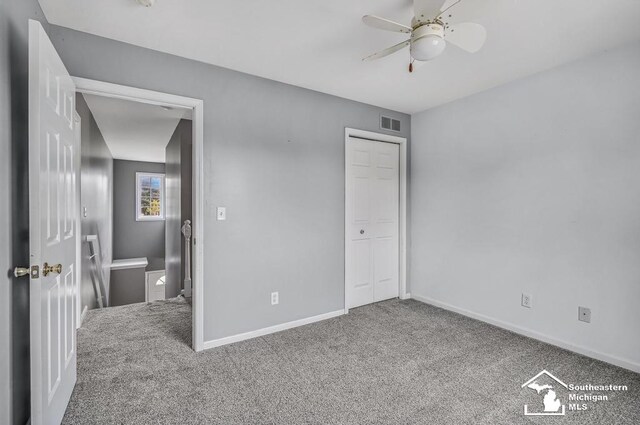 177 W Willis Rd, Saline, MI 48176 - unfurnished bedroom featuring carpet flooring, baseboards, a closet, and a ceiling fan