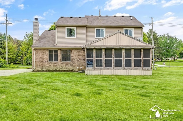 177 W Willis Rd, Saline, MI 48176 - rear view of property with a chimney, a lawn, a sunroom, and brick siding