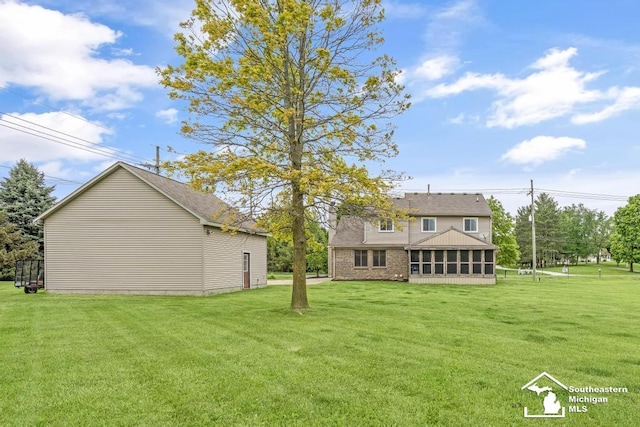 177 W Willis Rd, Saline, MI 48176 - back of house with a yard and a sunroom