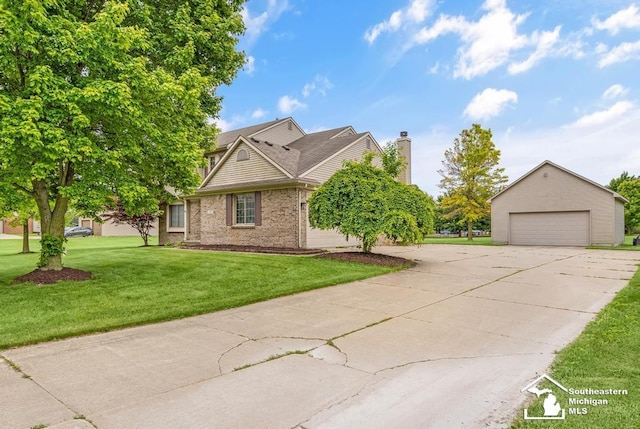 177 W Willis Rd, Saline, MI 48176 - view of front of home featuring a detached garage, a front yard, a chimney, brick siding, and an outdoor structure