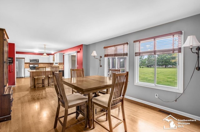 177 W Willis Rd, Saline, MI 48176 - dining space with light wood-style flooring and baseboards