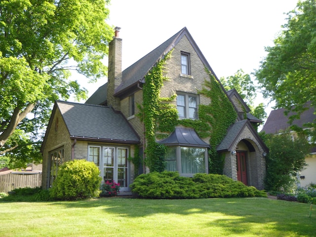 301 Sligh Blvd NE, Grand Rapids, MI 49505 - tudor house featuring a front lawn and a chimney