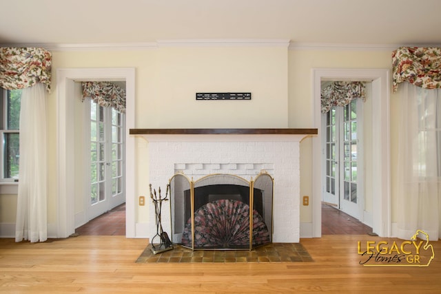 301 Sligh Blvd NE, Grand Rapids, MI 49505 - detailed view of crown molding, wood finished floors, and a fireplace