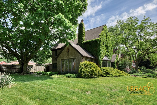 301 Sligh Blvd NE, Grand Rapids, MI 49505 - view of side of home featuring a chimney, roof with shingles, and brick siding