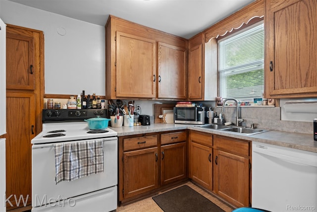634 E Lewiston Ave, Ferndale, MI 48220 - kitchen with white appliances, a sink, light countertops, and brown cabinetry