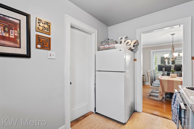 634 E Lewiston Ave, Ferndale, MI 48220 - kitchen featuring freestanding refrigerator, range, a chandelier, light wood-style flooring, and ornamental molding