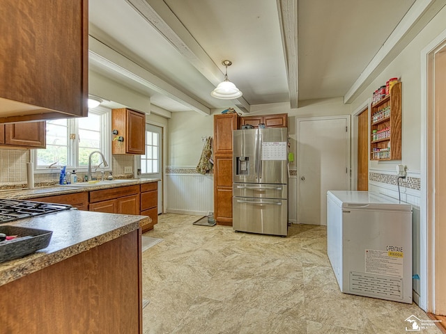 424 W 4th St, Monroe, MI 48161 - kitchen with stainless steel fridge, a sink, beamed ceiling, brown cabinets, and backsplash