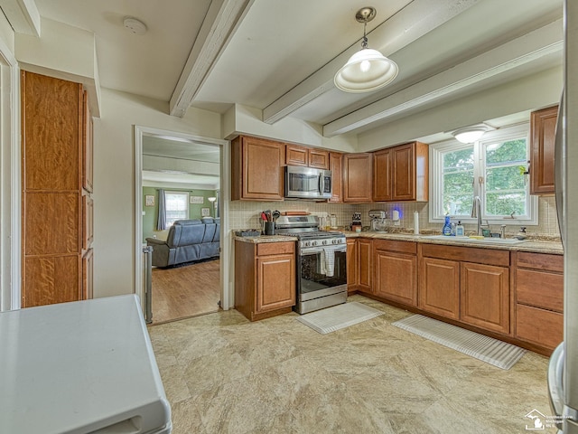 424 W 4th St, Monroe, MI 48161 - kitchen with appliances with stainless steel finishes, a sink, brown cabinetry, decorative backsplash, and beamed ceiling