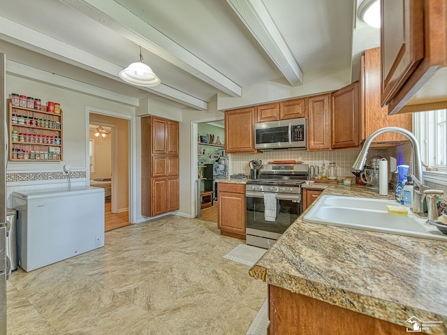 424 W 4th St, Monroe, MI 48161 - kitchen with appliances with stainless steel finishes, a sink, brown cabinets, tasteful backsplash, and beam ceiling