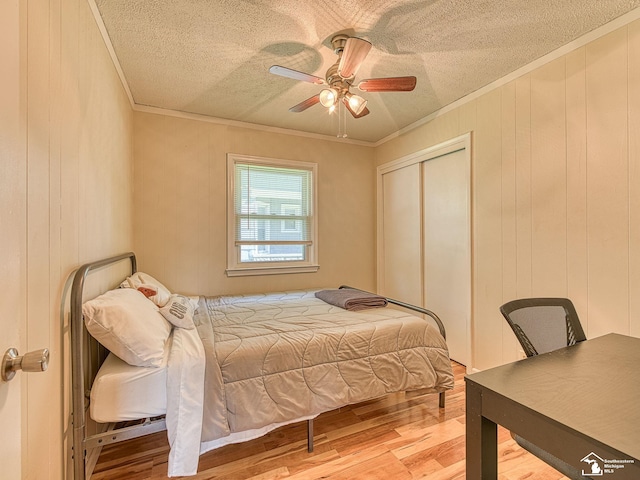 424 W 4th St, Monroe, MI 48161 - bedroom featuring wood finished floors, ornamental molding, a textured ceiling, a closet, and ceiling fan