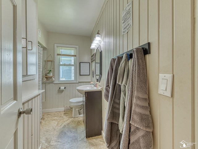 424 W 4th St, Monroe, MI 48161 - half bathroom featuring toilet, vanity, and a wainscoted wall