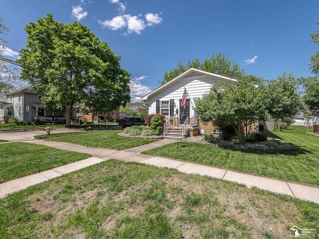 424 W 4th St, Monroe, MI 48161 - view of front facade featuring a front yard and brick siding