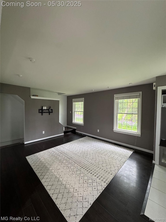 271 Inlet Ct, Novi, MI 48390 - unfurnished living room with baseboards and dark wood finished floors