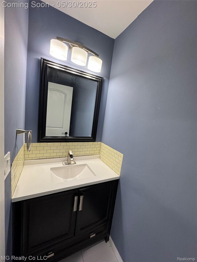 271 Inlet Ct, Novi, MI 48390 - bathroom featuring decorative backsplash, vanity, baseboards, and tile patterned flooring