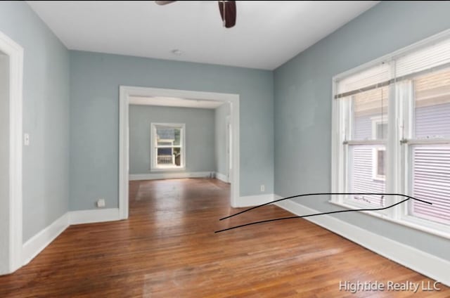 232 Oakley Pl NE, Grand Rapids, MI 49503 - empty room with wood finished floors, a ceiling fan, and baseboards