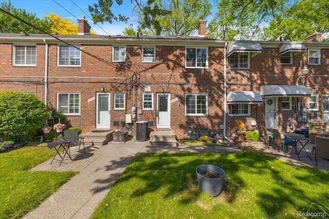 22865 Lakeshore Dr, Saint Clair Shores, MI 48080 - back of property featuring a chimney, a lawn, and brick siding