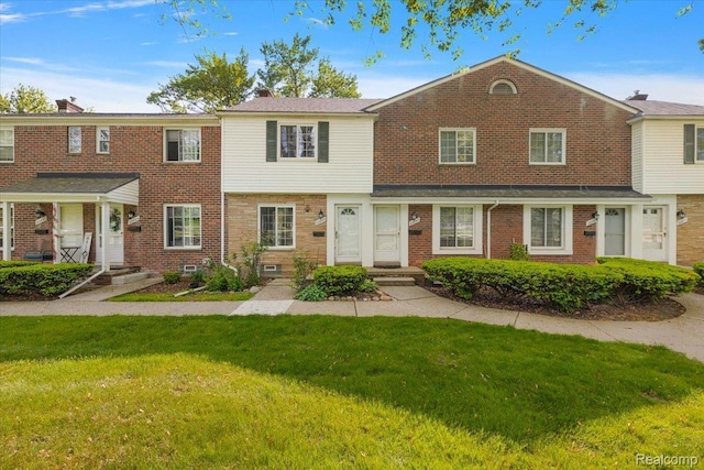 22865 Lakeshore Dr, Saint Clair Shores, MI 48080 - townhome / multi-family property featuring a front yard and brick siding