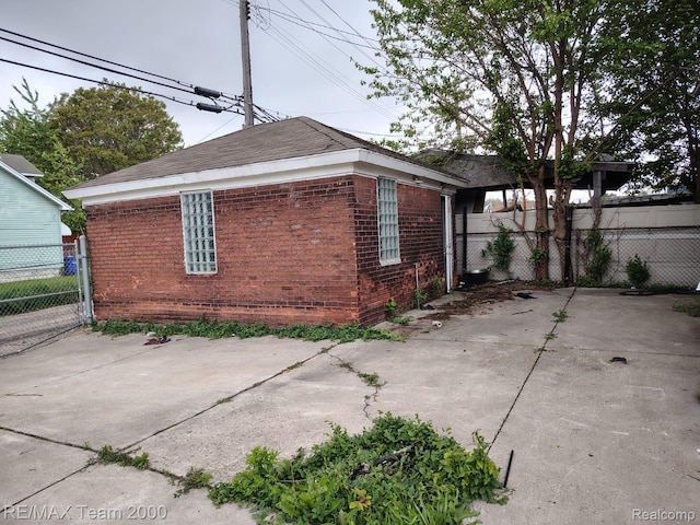 1601 Lawndale St, Highland Park, MI 48209 - view of home's exterior with brick siding and a patio area