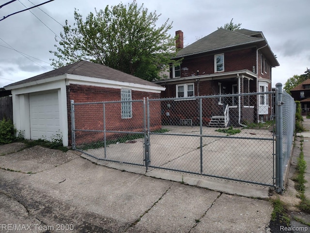 1601 Lawndale St, Highland Park, MI 48209 - rear view of property featuring brick siding, an outdoor structure, a gate, and a chimney