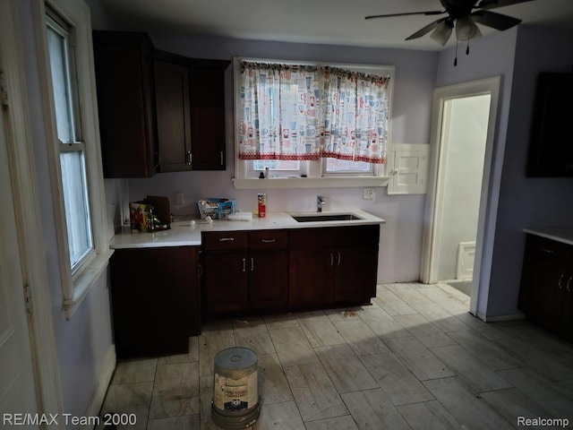 1601 Lawndale St, Highland Park, MI 48209 - kitchen featuring a sink, light countertops, ceiling fan, dark brown cabinetry, and wood finish floors