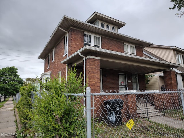1601 Lawndale St, Highland Park, MI 48209 - american foursquare style home featuring a porch and brick siding